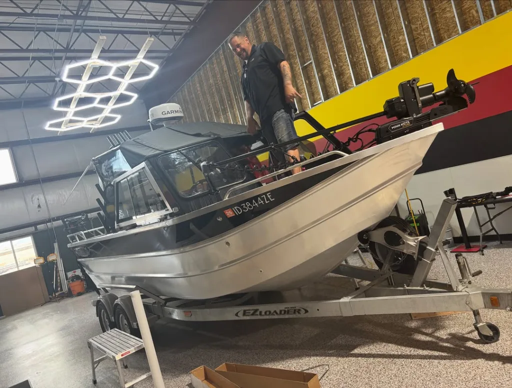 Aluminum fishing boat getting ceramic marine tint at Black Optix Tint West Haven